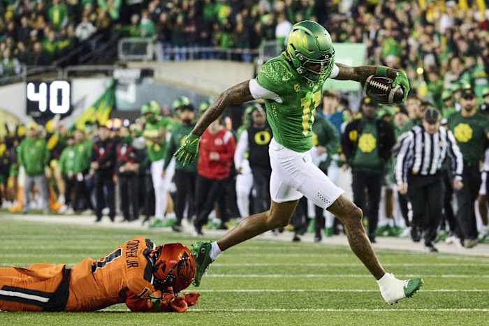 Nov 24, 2023; Eugene, Oregon, USA; Oregon Ducks wide receiver Troy Franklin (11) breaks away from Oregon State Beavers defensive back Ryan Cooper Jr. (1) for a touchdown reception during the first half at Autzen Stadium. Mandatory Credit: Troy Wayrynen-USA TODAY Sports  